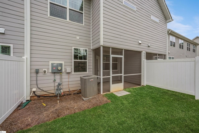 exterior space with central AC and a sunroom