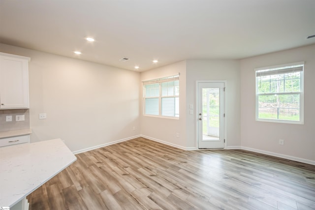 spare room featuring light wood-type flooring