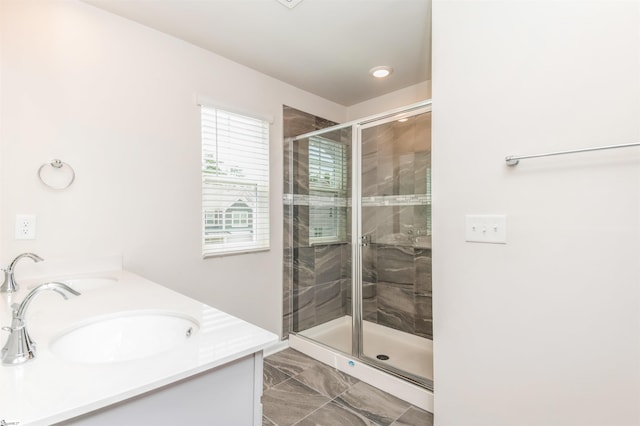 bathroom with tile patterned floors, vanity, and a shower with door