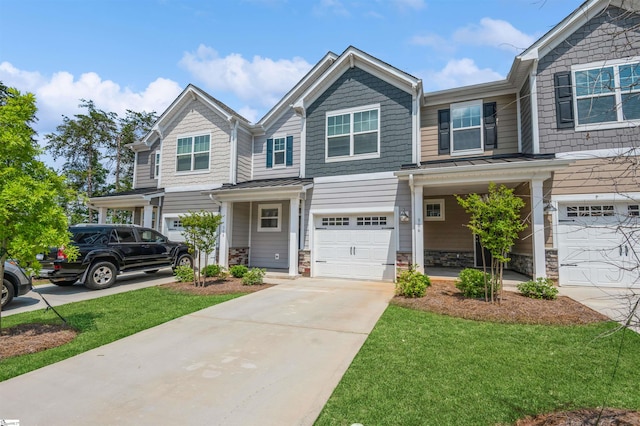 view of front of home with a front yard and a garage