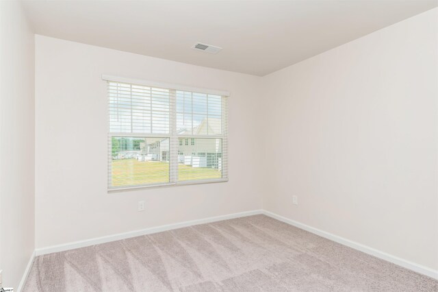 unfurnished bedroom with a closet and light colored carpet