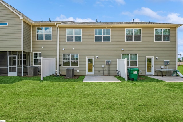 back of house with central AC, a lawn, and a patio area