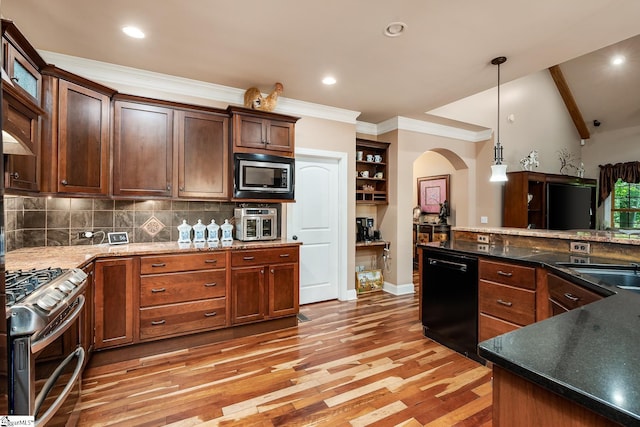 kitchen with tasteful backsplash, appliances with stainless steel finishes, hardwood / wood-style floors, and decorative light fixtures