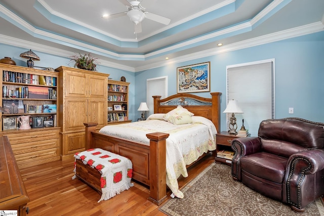 bedroom featuring ornamental molding, dark hardwood / wood-style flooring, and a raised ceiling