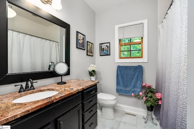 bathroom featuring vanity and toilet