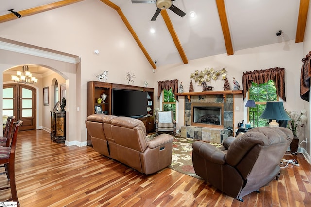 living room with beam ceiling, light hardwood / wood-style flooring, high vaulted ceiling, and plenty of natural light