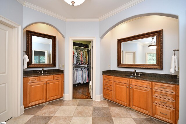 bathroom with vanity, crown molding, and tile patterned flooring