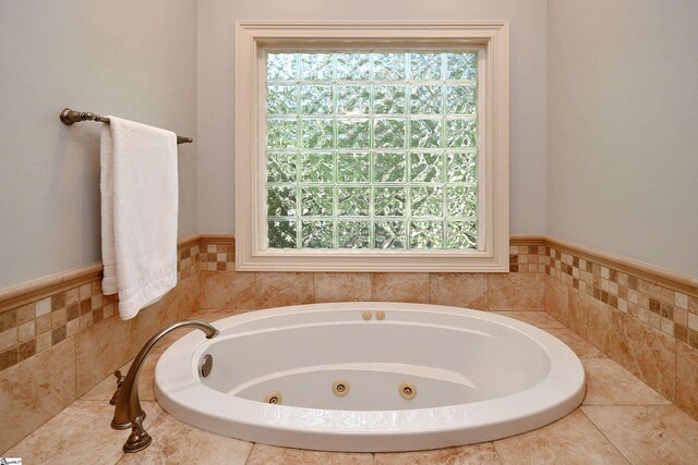 bathroom with a bath and a healthy amount of sunlight