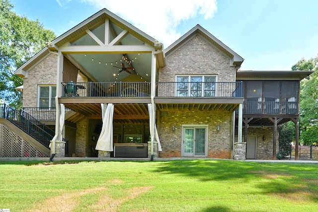 view of front of home with a front yard and ceiling fan