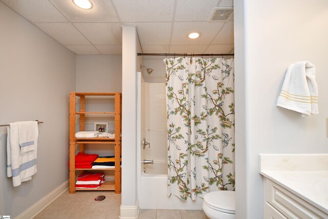 full bathroom featuring toilet, shower / bath combination with curtain, a drop ceiling, tile patterned flooring, and vanity