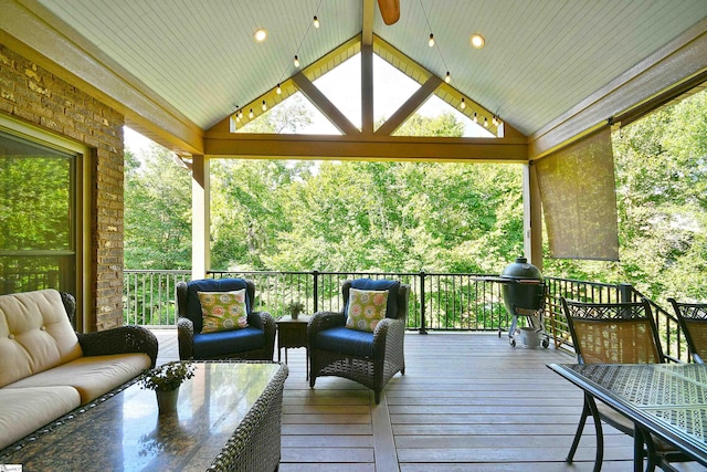 wooden deck featuring an outdoor hangout area, grilling area, and a gazebo