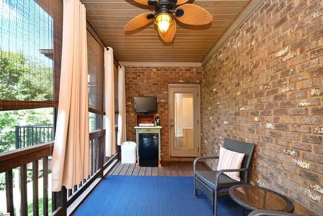 unfurnished sunroom featuring ceiling fan and plenty of natural light