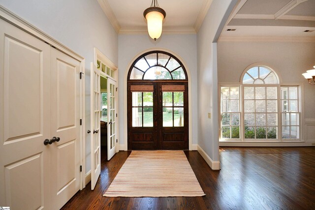 entrance foyer featuring crown molding, dark hardwood / wood-style floors, and french doors