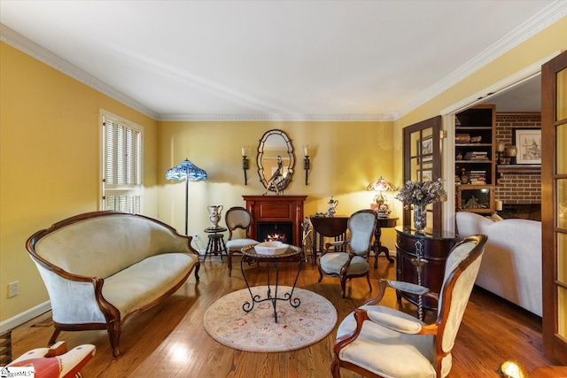 living area with dark wood-type flooring and ornamental molding