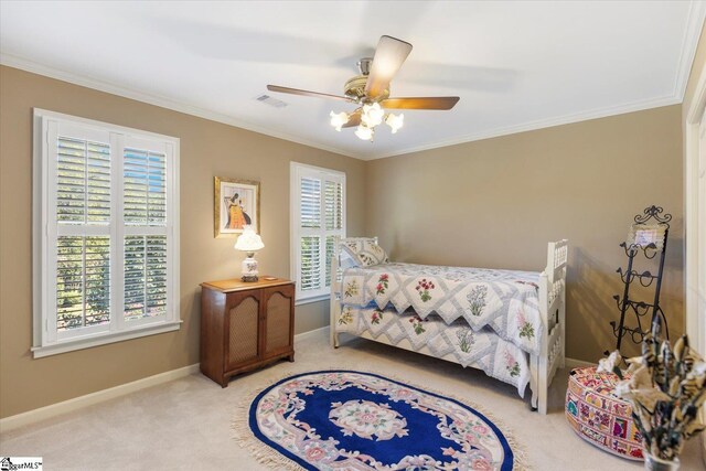 carpeted bedroom with ceiling fan, a raised ceiling, and crown molding