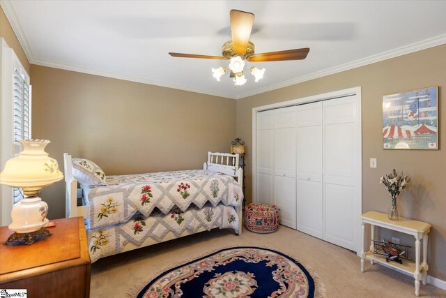 bedroom with ceiling fan, ensuite bathroom, a raised ceiling, crown molding, and light colored carpet