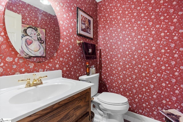 bathroom featuring vanity, toilet, and tile patterned flooring