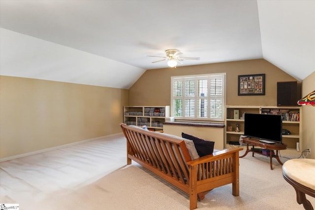 interior space featuring ceiling fan, vaulted ceiling, and light carpet