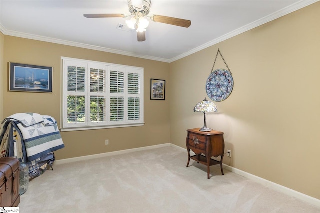 sitting room featuring ceiling fan, ornamental molding, and light colored carpet