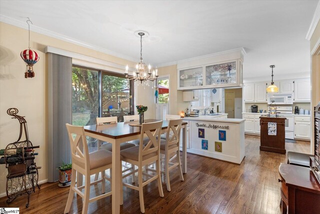 dining area with sink, a notable chandelier, crown molding, and dark hardwood / wood-style flooring