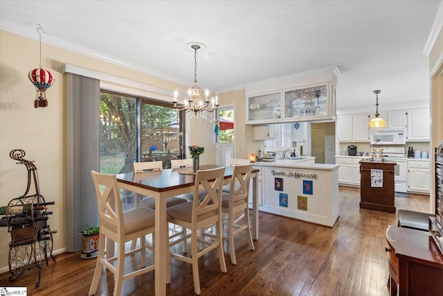 dining space with crown molding, an inviting chandelier, dark hardwood / wood-style floors, and sink