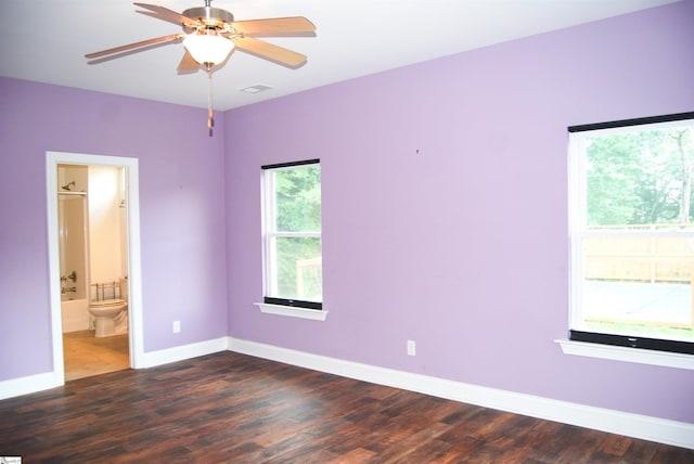 unfurnished room with visible vents, baseboards, wood finished floors, and a ceiling fan