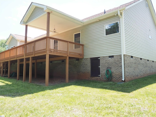 back of house featuring a deck and a yard