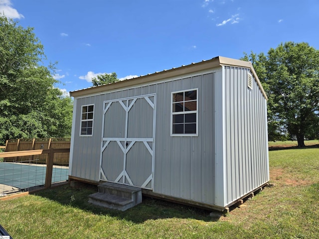 view of shed featuring fence