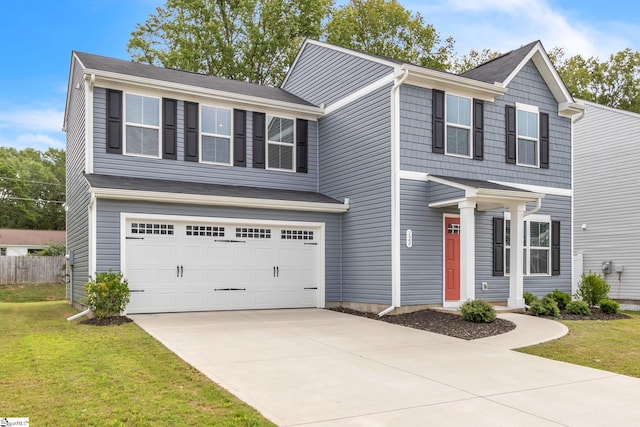 view of front of house with a front lawn and a garage