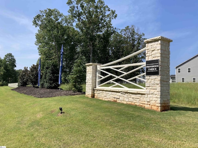 community / neighborhood sign featuring a lawn