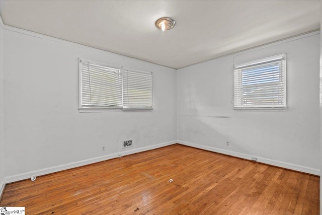 spare room with hardwood / wood-style floors