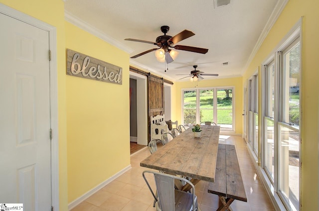 dining area featuring light tile patterned floors, a barn door, and ornamental molding