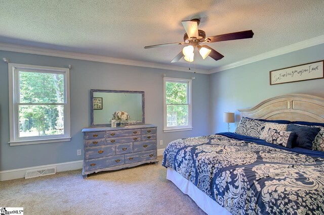 carpeted bedroom with multiple windows, crown molding, and a textured ceiling