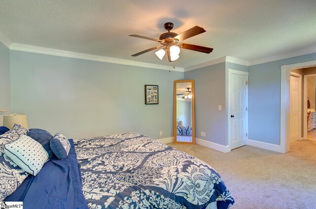 carpeted bedroom featuring a textured ceiling, ceiling fan, and ornamental molding