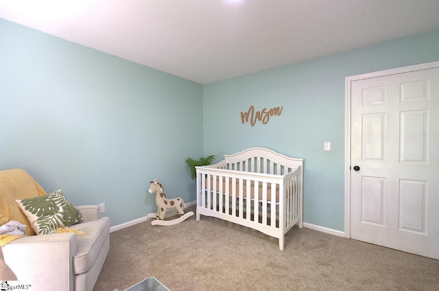 carpeted bedroom featuring a crib