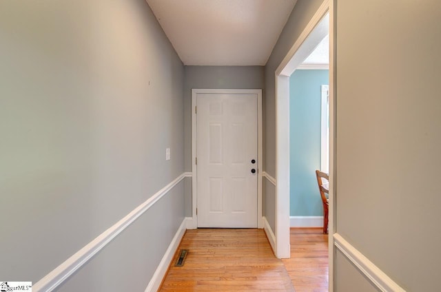 hallway with light hardwood / wood-style flooring