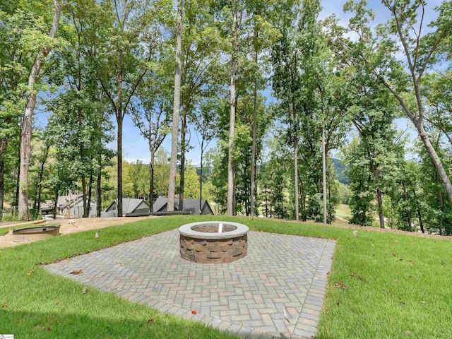 view of yard featuring a patio and an outdoor fire pit