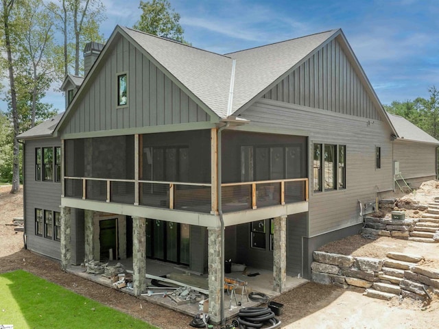 back of property featuring a sunroom and a patio area