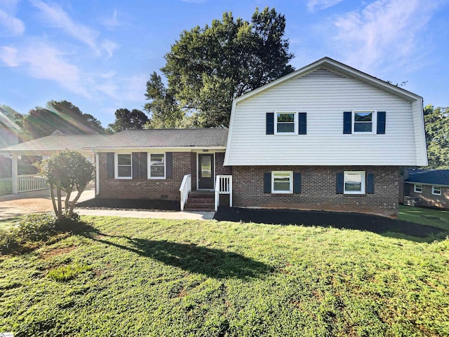 split level home with a front yard, crawl space, and brick siding