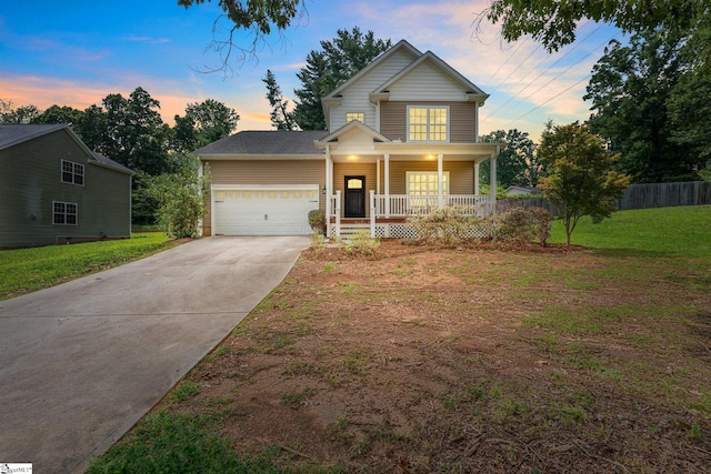 view of front of property featuring a garage, covered porch, and a yard