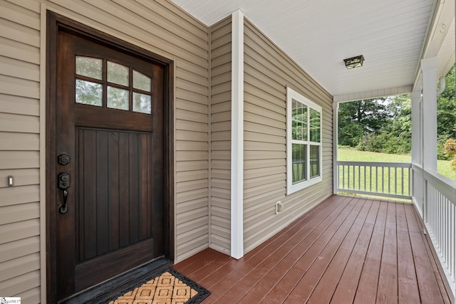 view of exterior entry featuring a porch