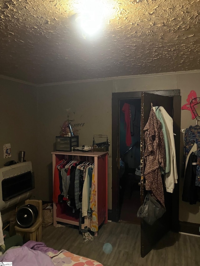 bedroom with a textured ceiling and hardwood / wood-style flooring