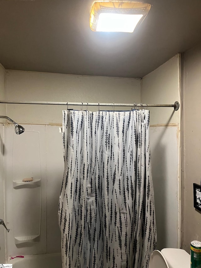 bathroom with shower / bath combination with curtain