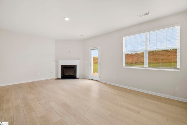 unfurnished living room with light wood-type flooring