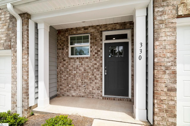 property entrance featuring a garage and covered porch