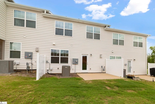 back of property with a patio area, a yard, and cooling unit