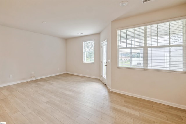 unfurnished room with light wood-type flooring