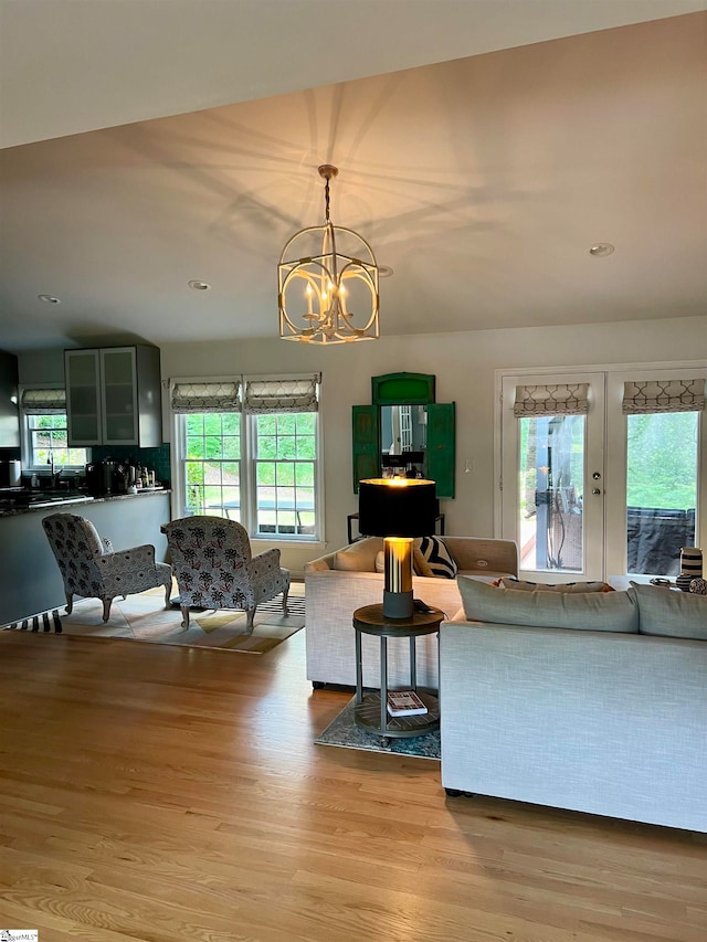 living room with a notable chandelier and light hardwood / wood-style floors