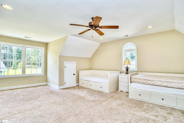 unfurnished bedroom with ceiling fan, lofted ceiling, multiple windows, and light carpet