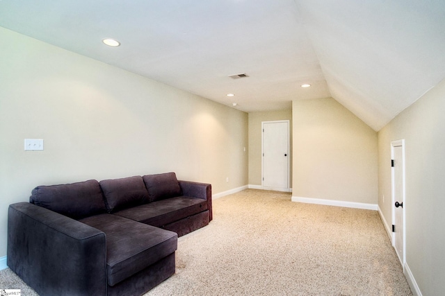 carpeted living room with lofted ceiling